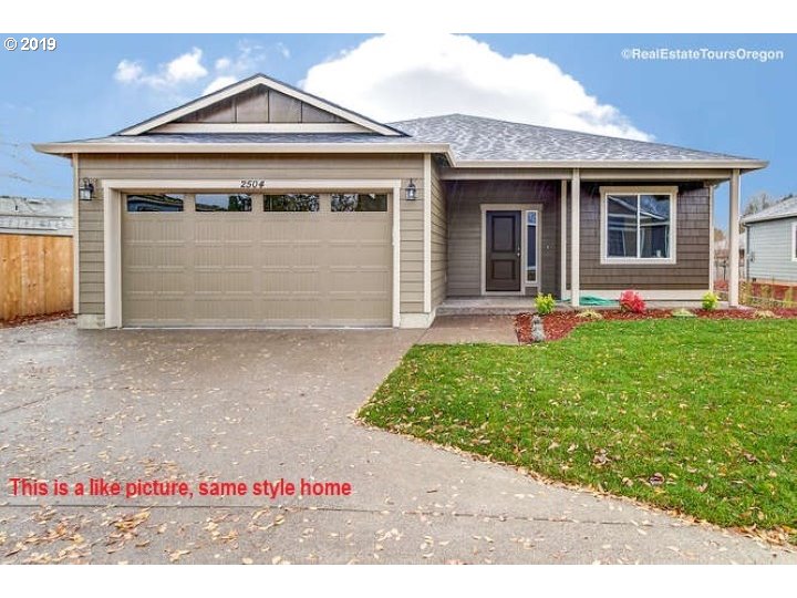a front view of a house with a garden and yard