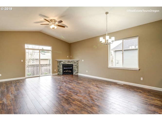 1060 6th Street Gervais, OR 97026 - Photo 13 of 30 a view of an empty room with wooden floor and a window