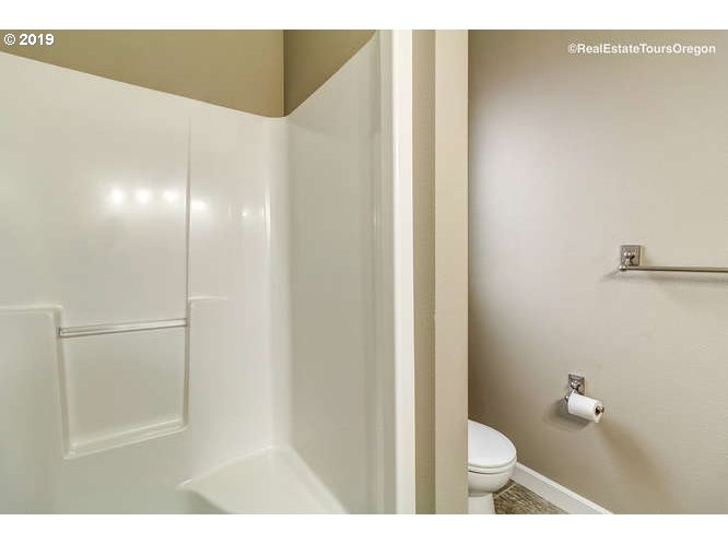 1060 6th Street Gervais, OR 97026 - Photo 24 of 30 a bathroom with a toilet and a shower