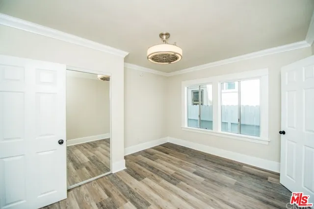 a bathroom with a granite countertop toilet sink and mirror