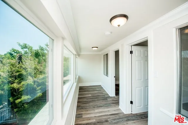 a view of a room with a wooden floor