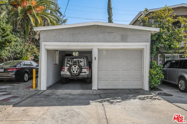 a view of a car parked front of garage