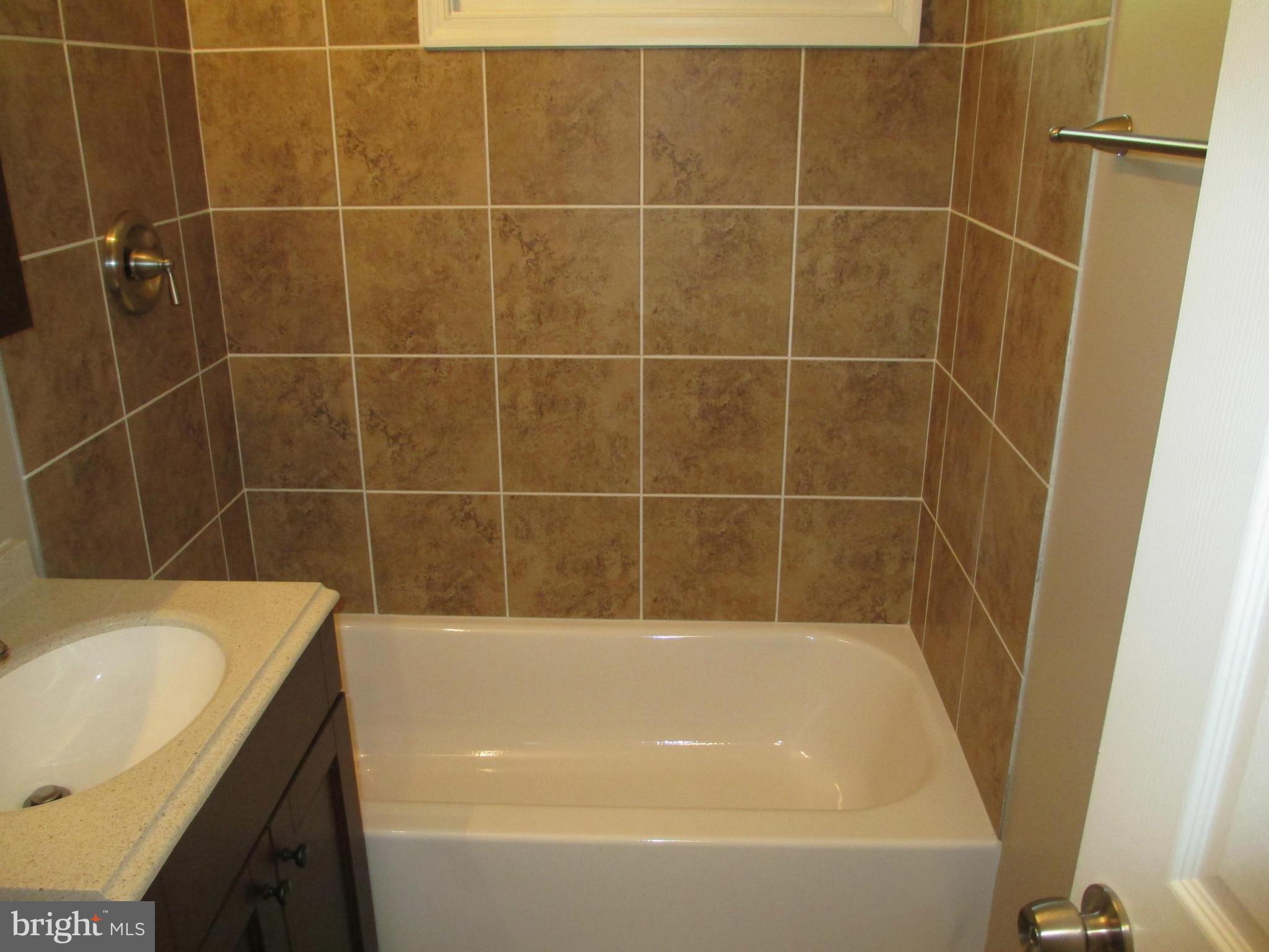 7634 Muncy Road Hyattsville, MD 20785 - Photo 14 of 21 a bathroom with a bath tub