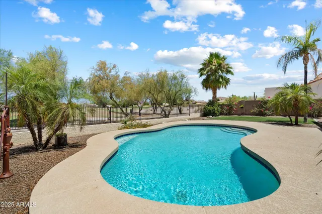 a view of a house with swimming pool and sitting area