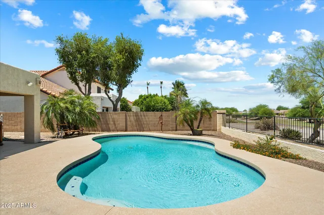 a view of a house with backyard and a tree