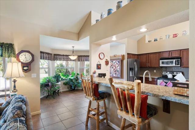 a view of a dining room with furniture and a window