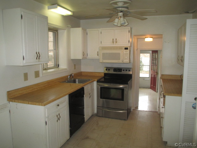 1201 Black Heath Road Midlothian, VA 23113 - Photo 8 of 17 a kitchen with stainless steel appliances a stove sink and cabinets