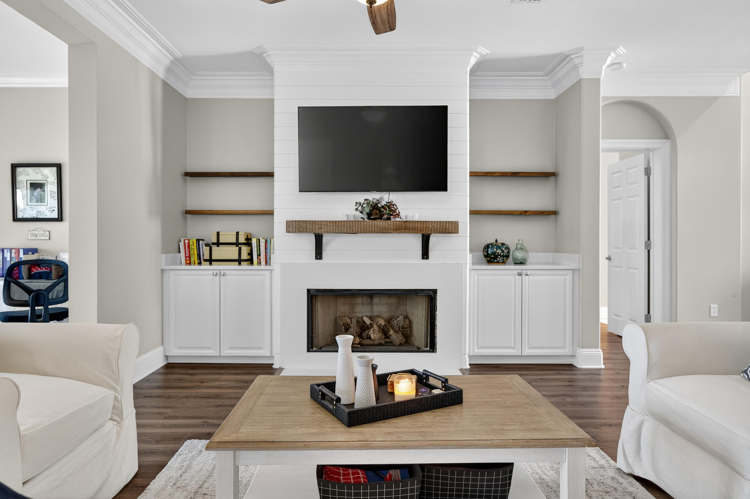 298 Ketch Court Destin, FL 32541 - Photo 13 of 79 a living room with furniture a flat screen tv and a fireplace