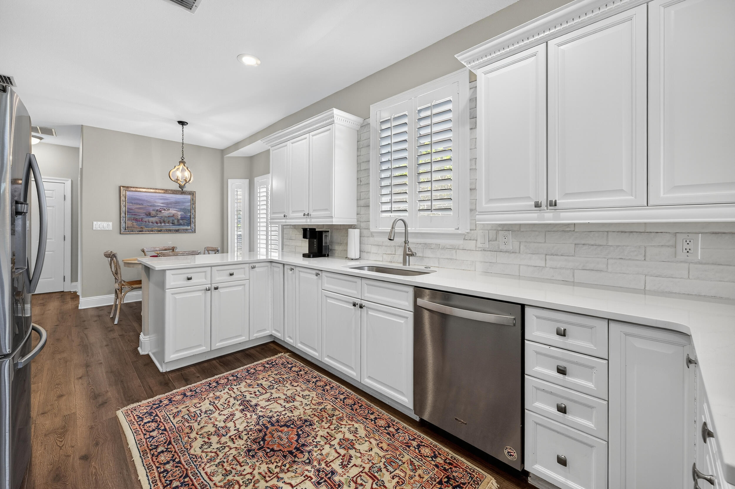 298 Ketch Court Destin, FL 32541 - Photo 19 of 79 a kitchen with white cabinets and white appliances