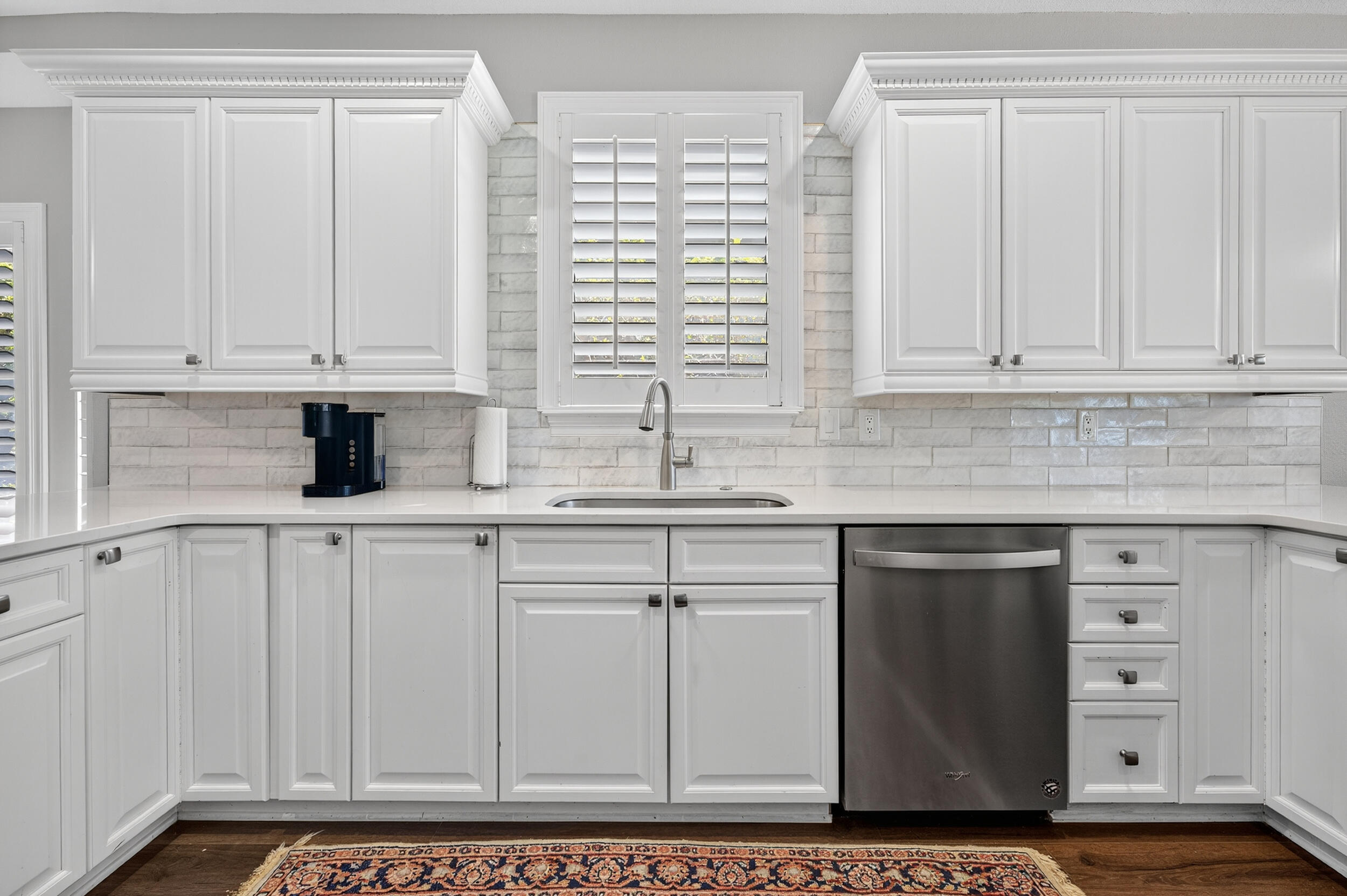 298 Ketch Court Destin, FL 32541 - Photo 23 of 79 a kitchen with stainless steel appliances granite countertop a sink and dishwasher with white cabinets