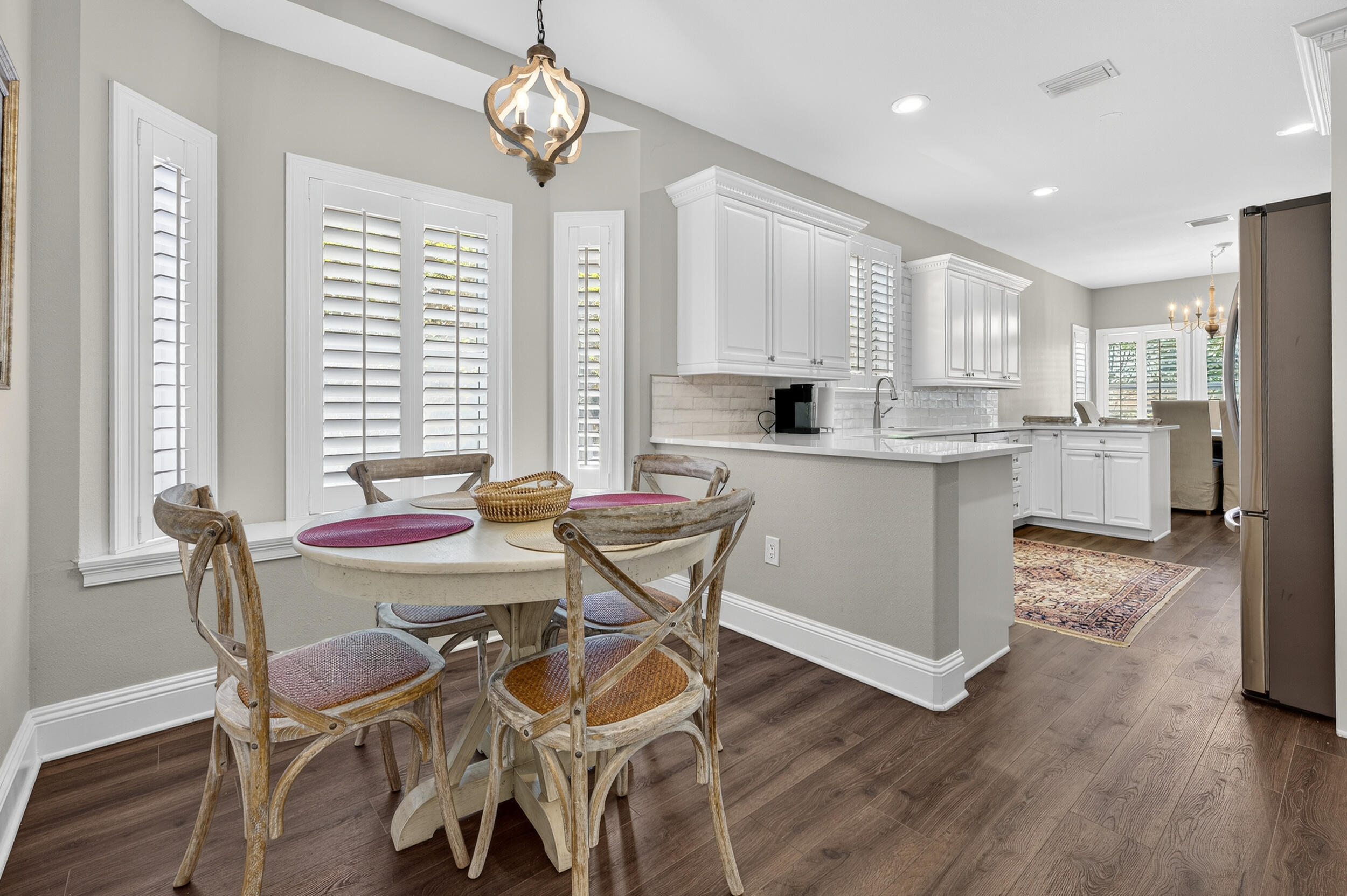 298 Ketch Court Destin, FL 32541 - Photo 26 of 79 a view of a dining room with furniture large window and wooden floor