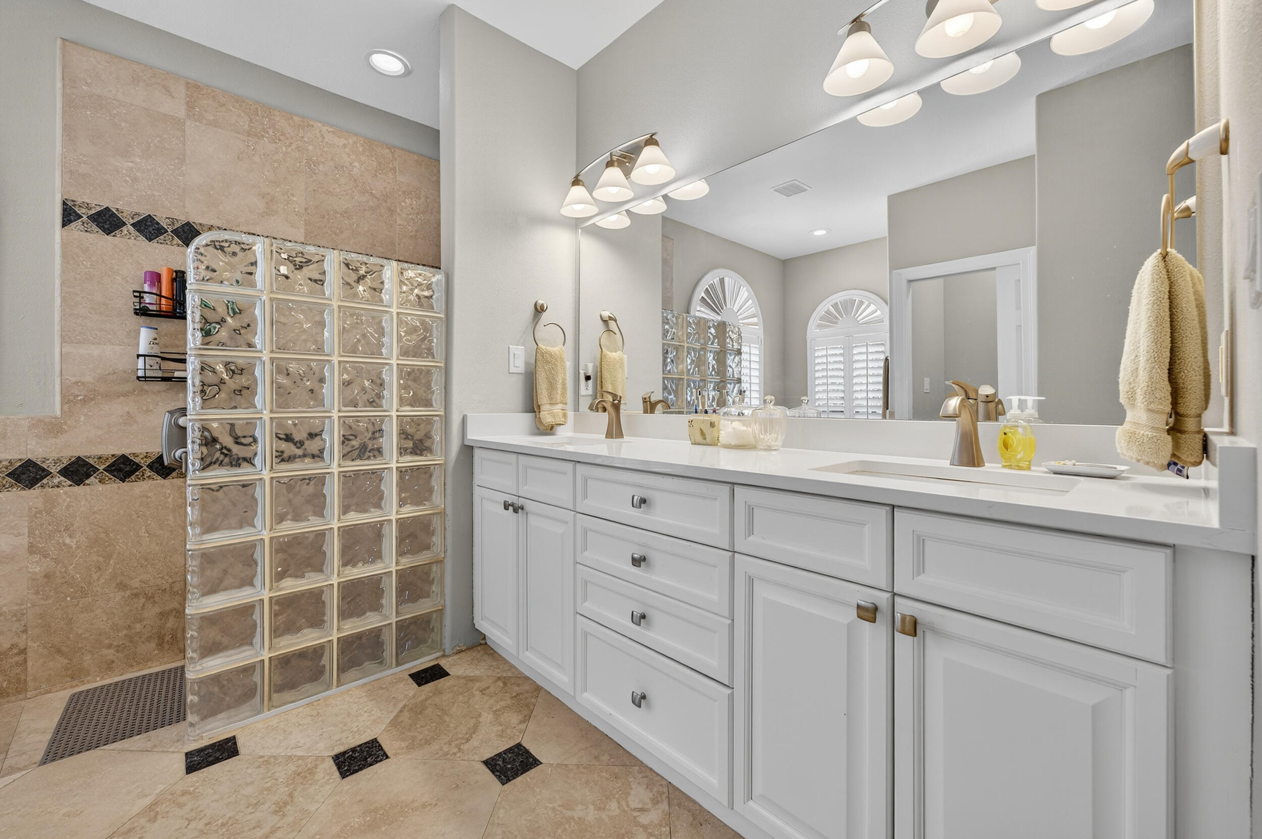 298 Ketch Court Destin, FL 32541 - Photo 35 of 79 a bathroom with a double vanity sink mirror and shower