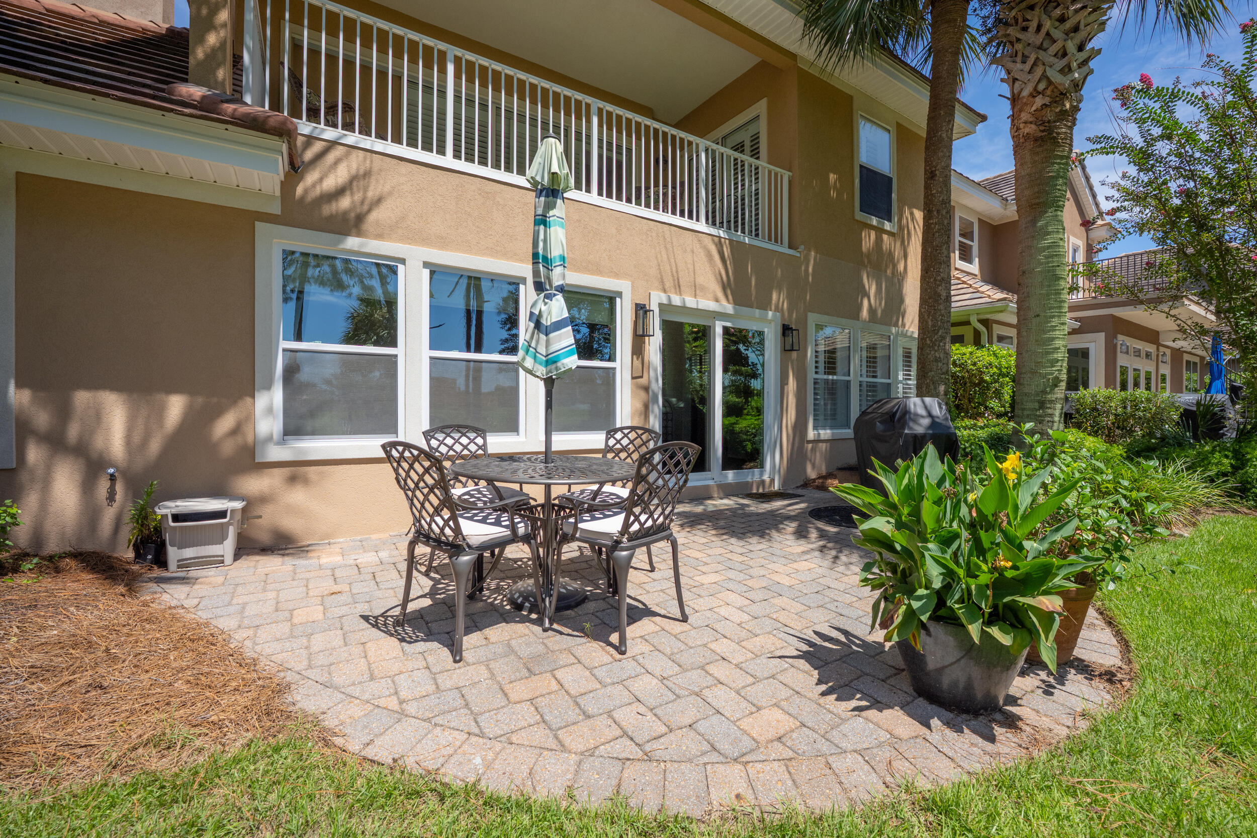 298 Ketch Court Destin, FL 32541 - Photo 67 of 79 a view of a patio with table and chairs and potted plants