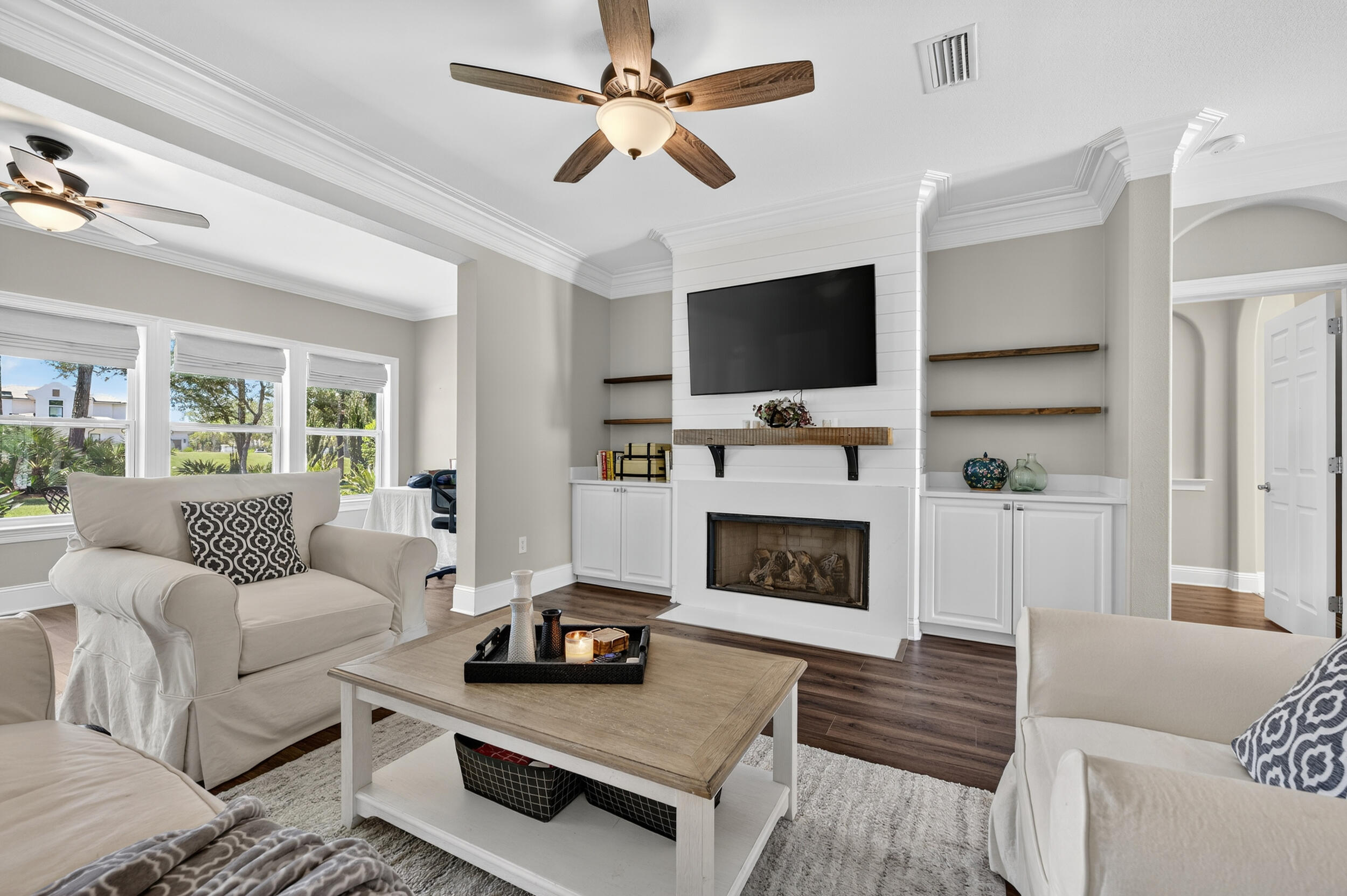 298 Ketch Court Destin, FL 32541 - Photo 8 of 79 a living room with furniture a flat screen tv and a fireplace