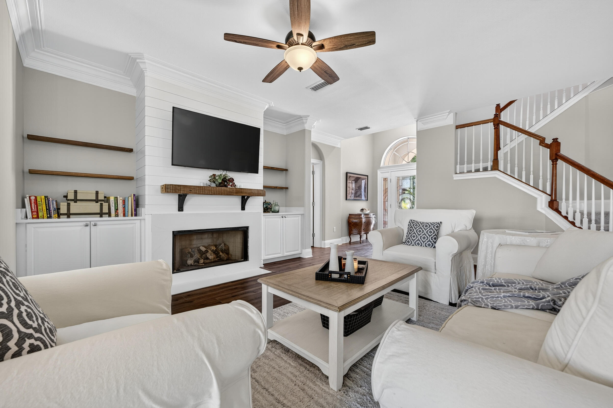 298 Ketch Court Destin, FL 32541 - Photo 9 of 79 a living room with furniture a flat screen tv and a fireplace