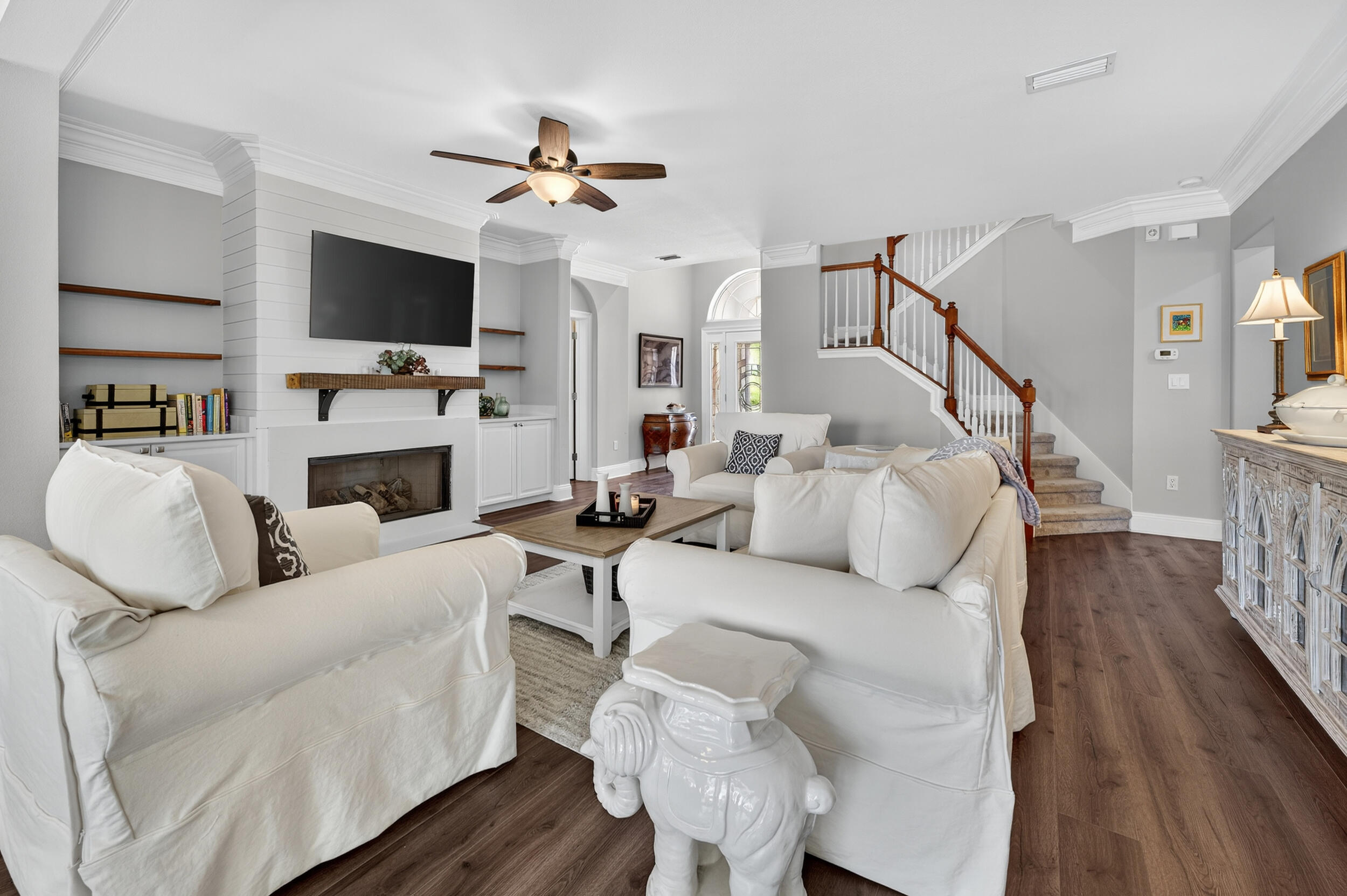 298 Ketch Court Destin, FL 32541 - Photo 10 of 79 a living room with furniture a flat screen tv and a fireplace