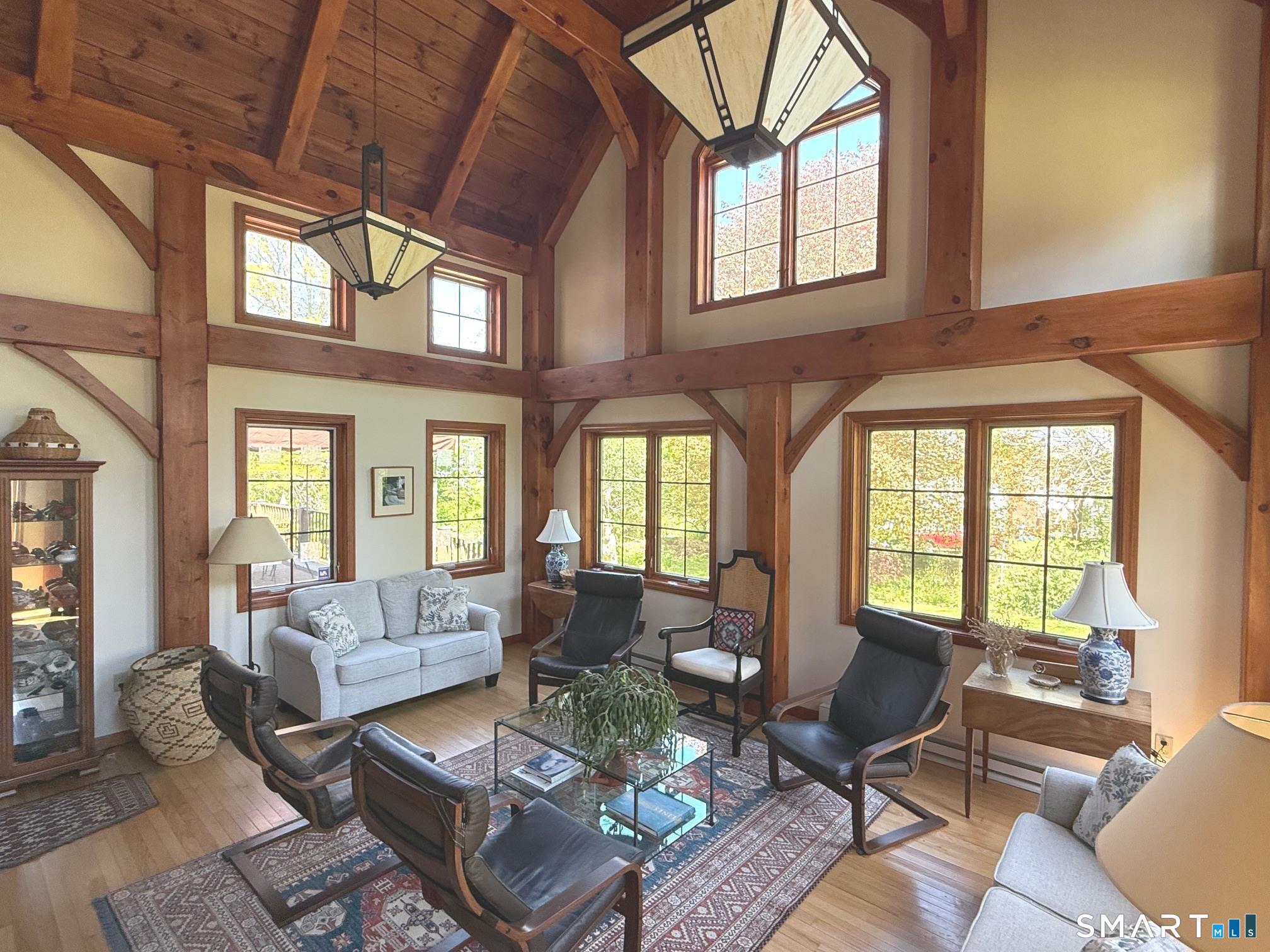 8 Ivy Road Stonington, CT 06355 - Photo 7 of 30 a living room with furniture a fireplace and large windows