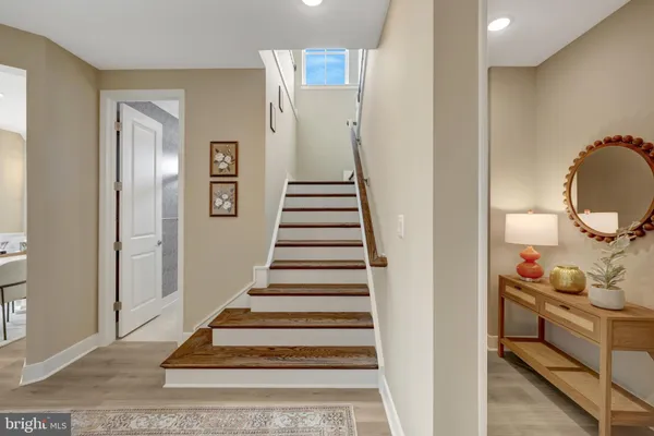 a view of a livingroom with wooden floor and a bathroom