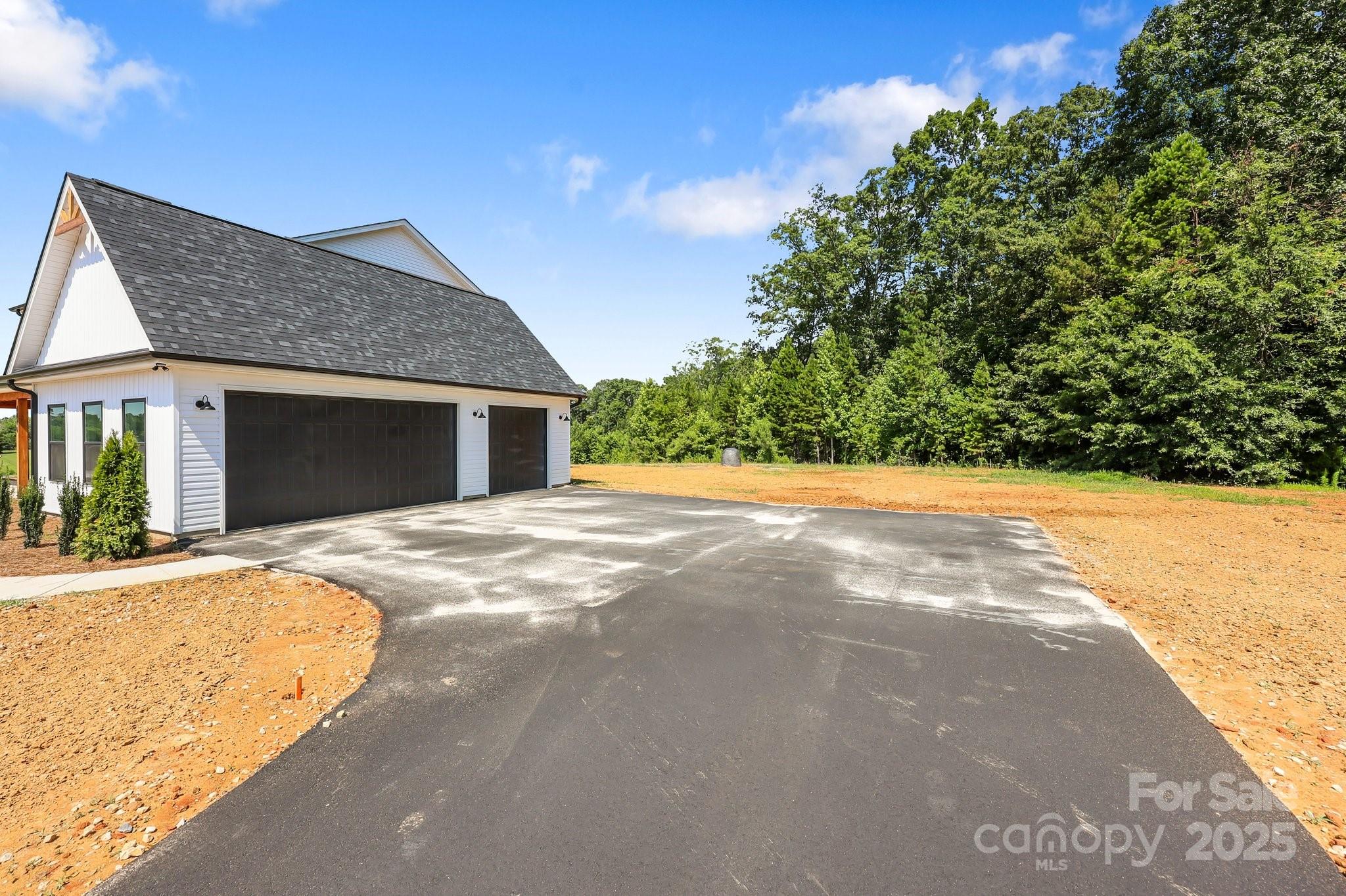 4040 Daugherty Road China Grove, NC 28023 - Photo 11 of 45 a view of yellow house with a yard and large tree