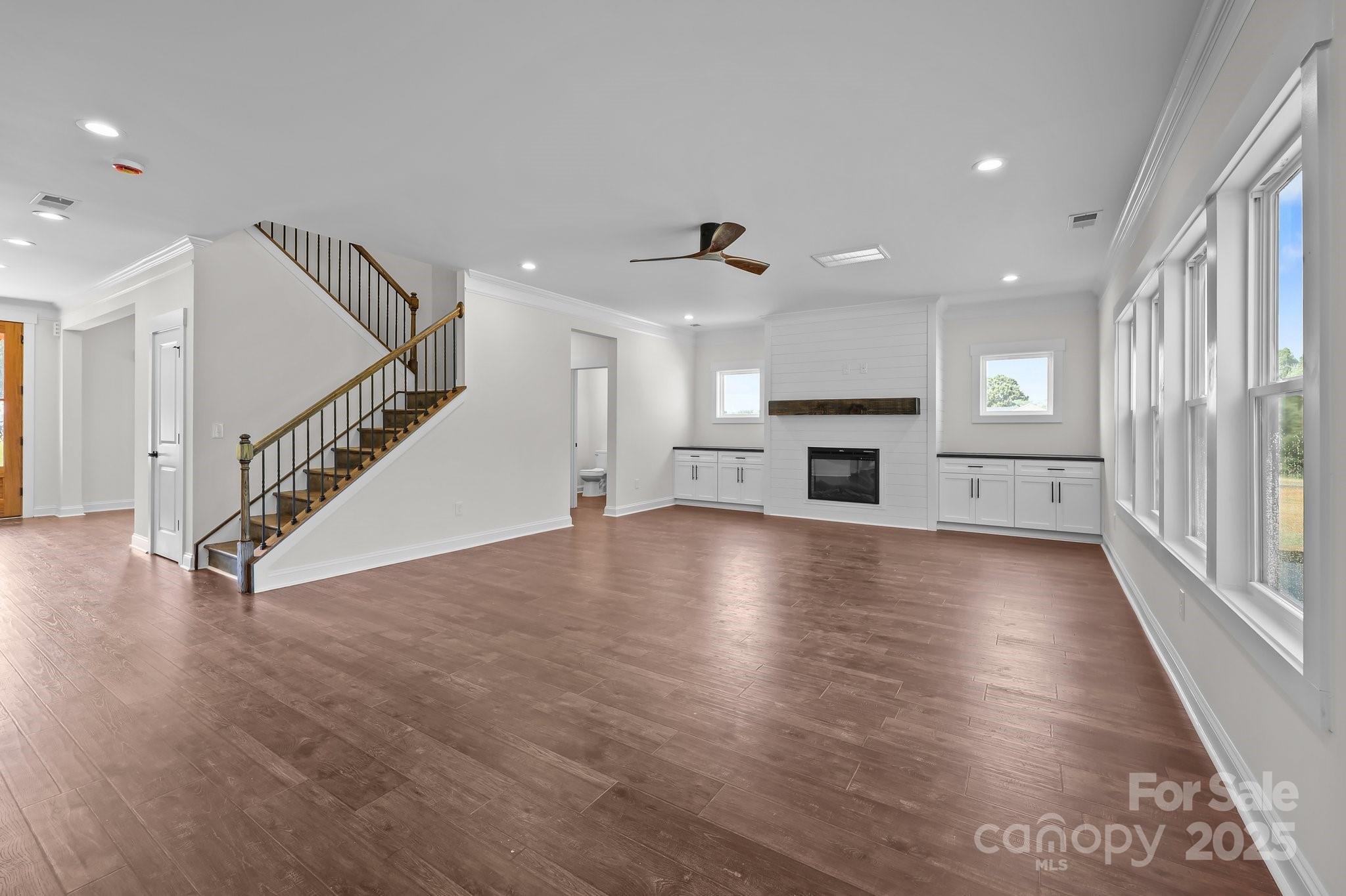 4040 Daugherty Road China Grove, NC 28023 - Photo 21 of 45 an empty room with wooden floor fireplace and windows