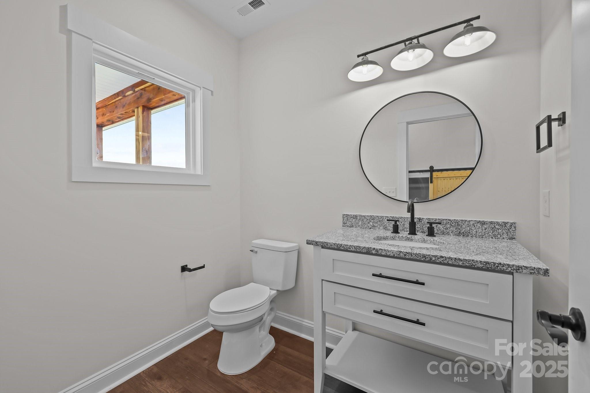 4040 Daugherty Road China Grove, NC 28023 - Photo 32 of 45 a bathroom with a toilet a sink and a mirror