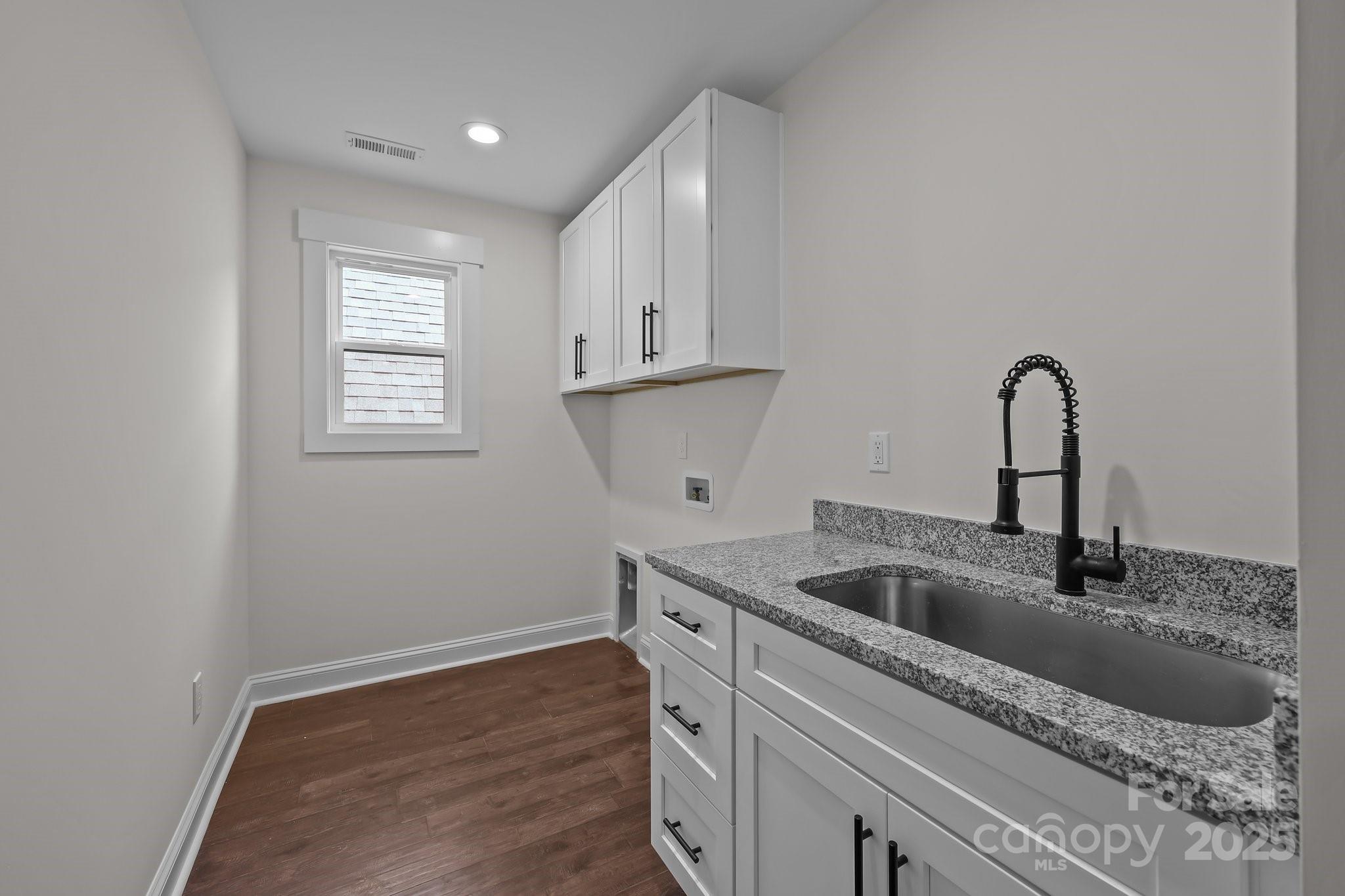 4040 Daugherty Road China Grove, NC 28023 - Photo 41 of 45 a kitchen with stainless steel appliances granite countertop a sink a window and white cabinets
