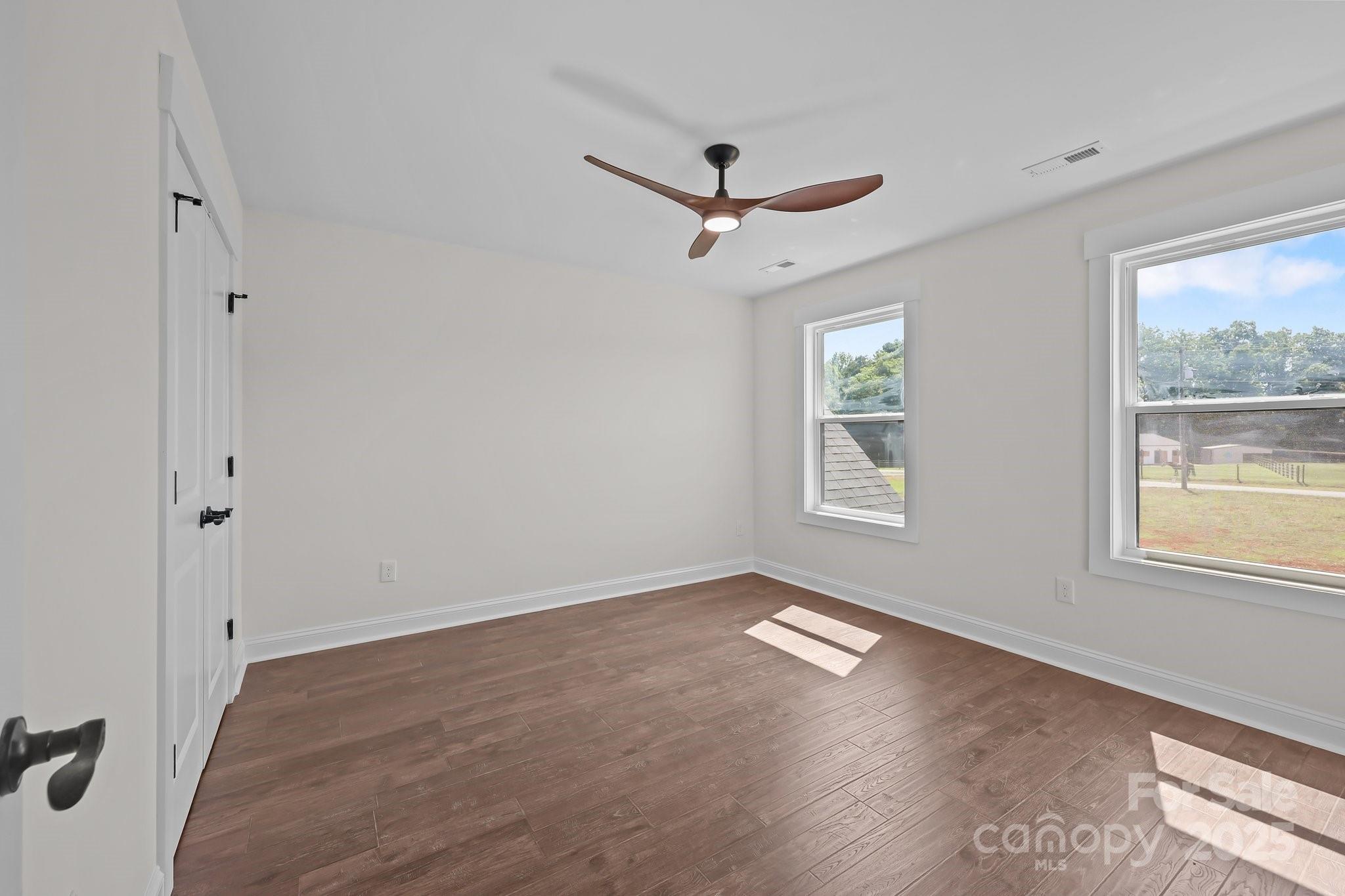 4040 Daugherty Road China Grove, NC 28023 - Photo 42 of 45 a view of empty room with wooden floor and fan