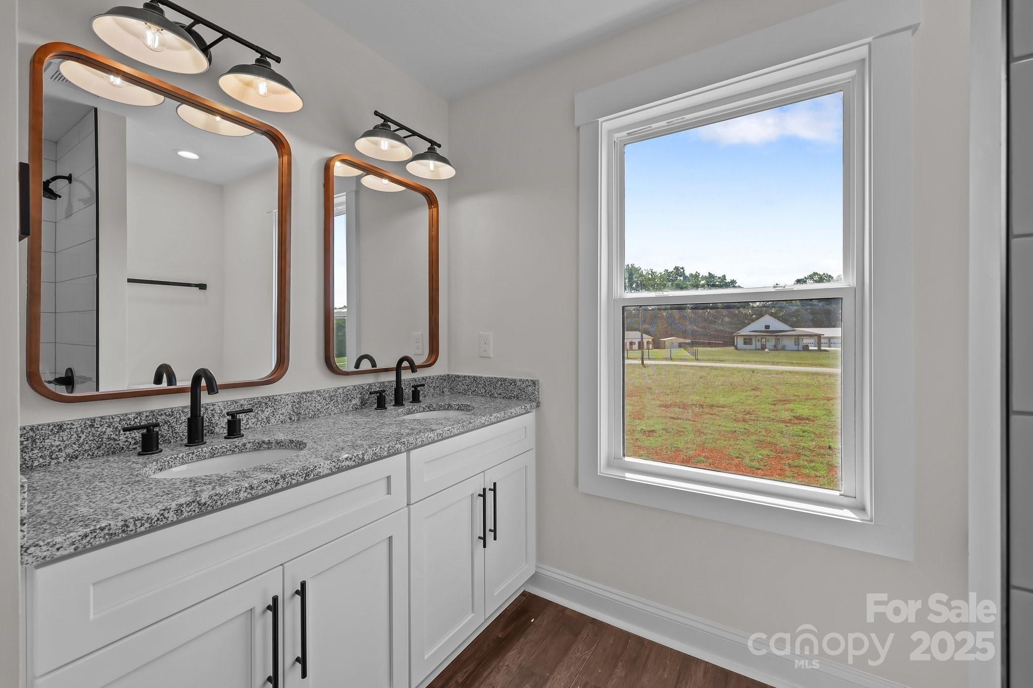 4040 Daugherty Road China Grove, NC 28023 - Photo 45 of 45 a bathroom with a granite countertop sink a large mirror and a window