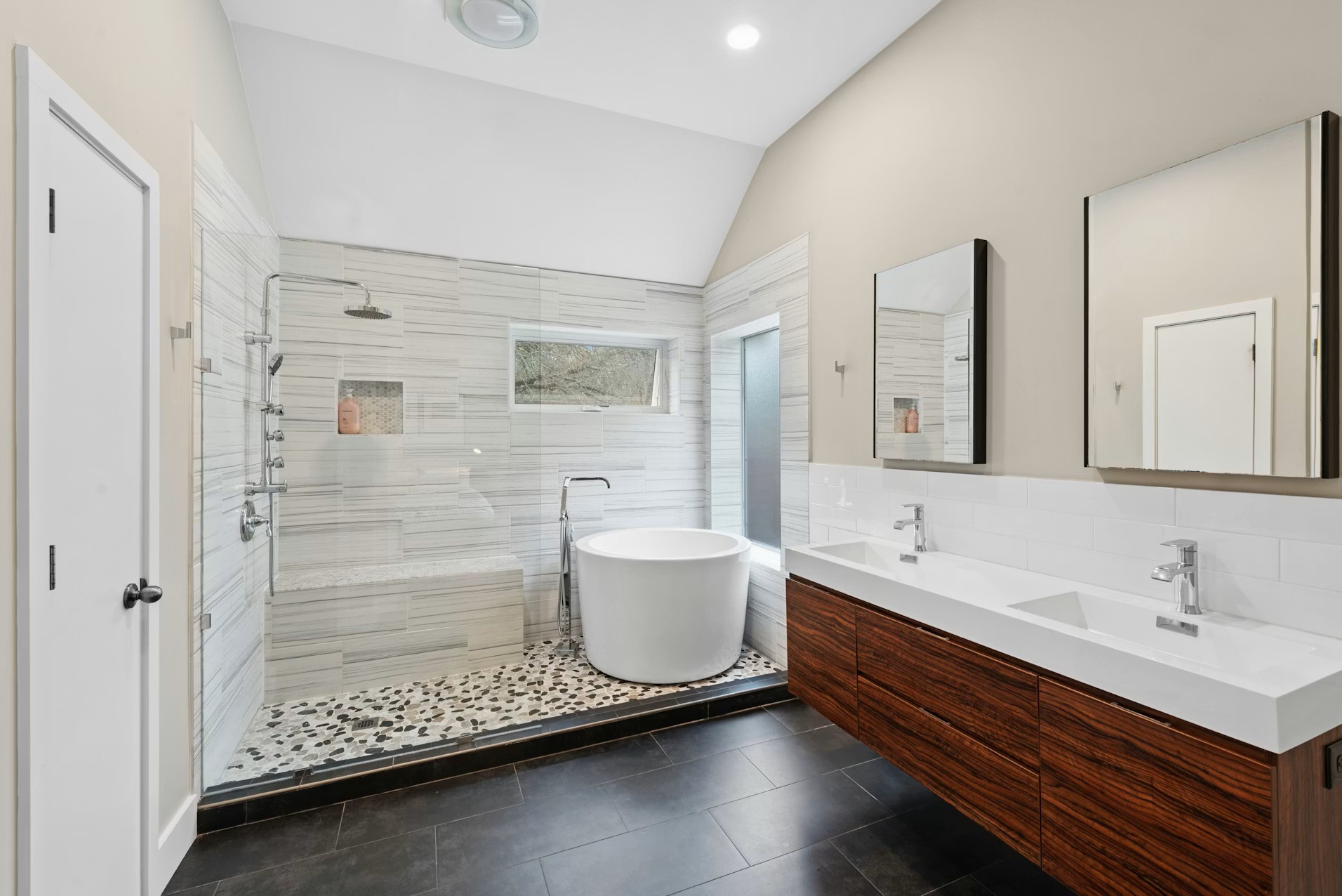 320 El Socorro Lane Austin, TX 78732 - Photo 23 of 40 a bathroom with a double vanity sink toilet mirror and shower