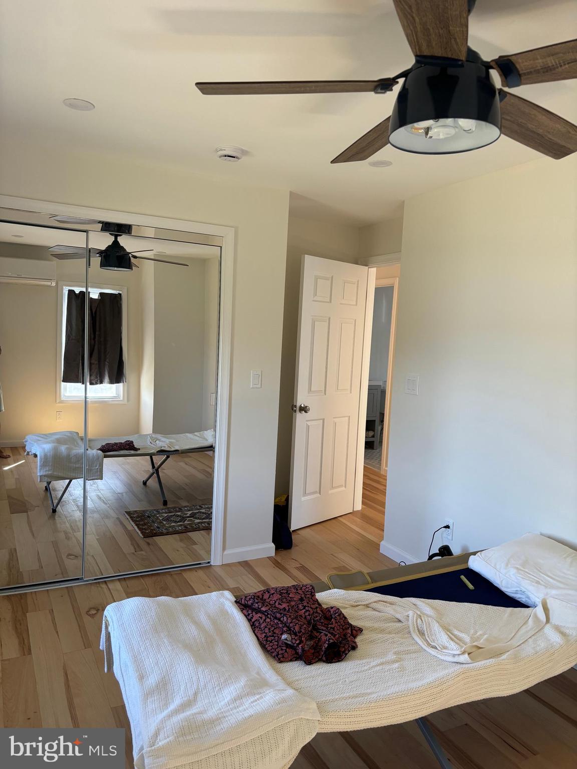 7501 Church Hill Road, Unit 5 Chestertown, MD 21620 - Photo 15 of 17 a bedroom with a bed and wooden floor
