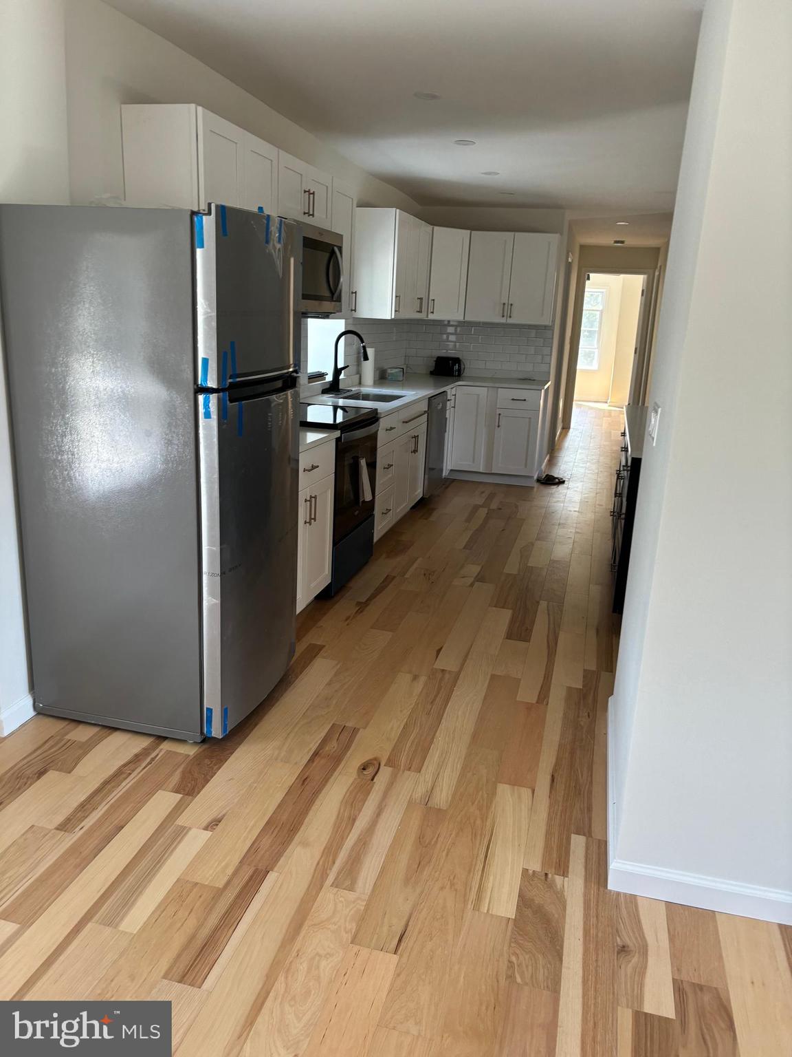 7501 Church Hill Road, Unit 5 Chestertown, MD 21620 - Photo 6 of 17 a kitchen with granite countertop a refrigerator and a sink