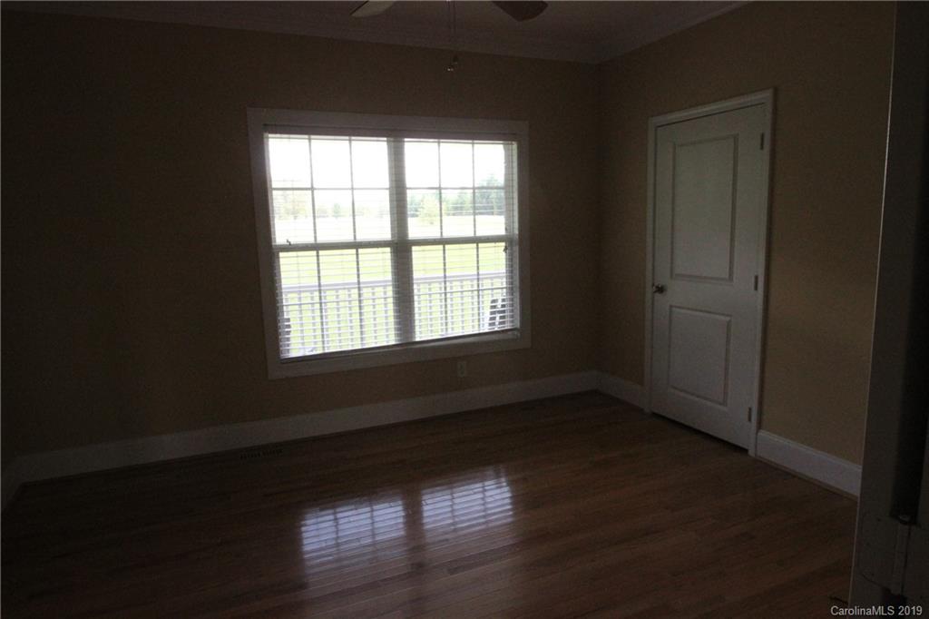 526 Maynard Grayson Road Clover, SC 29710 - Photo 12 of 19 a view of an empty room with wooden floor and a window