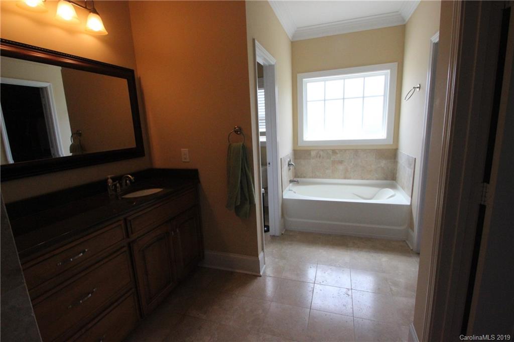 526 Maynard Grayson Road Clover, SC 29710 - Photo 15 of 19 a bathroom with a bathtub a sink a vanity and a window