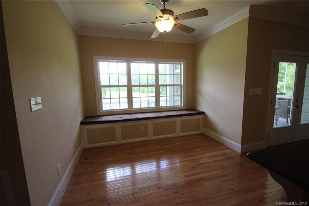 526 Maynard Grayson Road Clover, SC 29710 - Photo 7 of 19 a empty room with wooden floor and windows