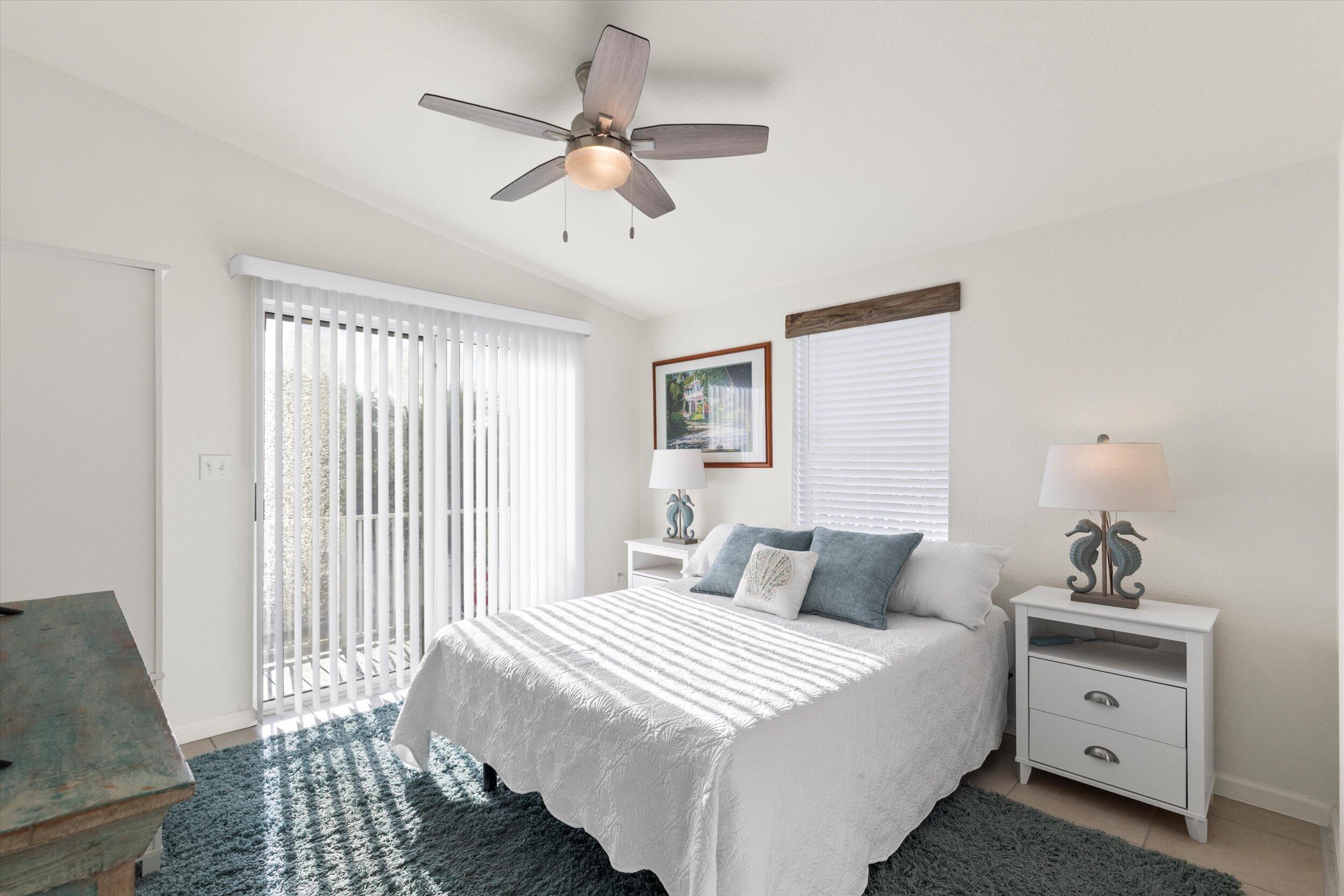 157 Mars Lane Key West, FL 33040 - Photo 20 of 41 a bedroom with a bed and a chandelier