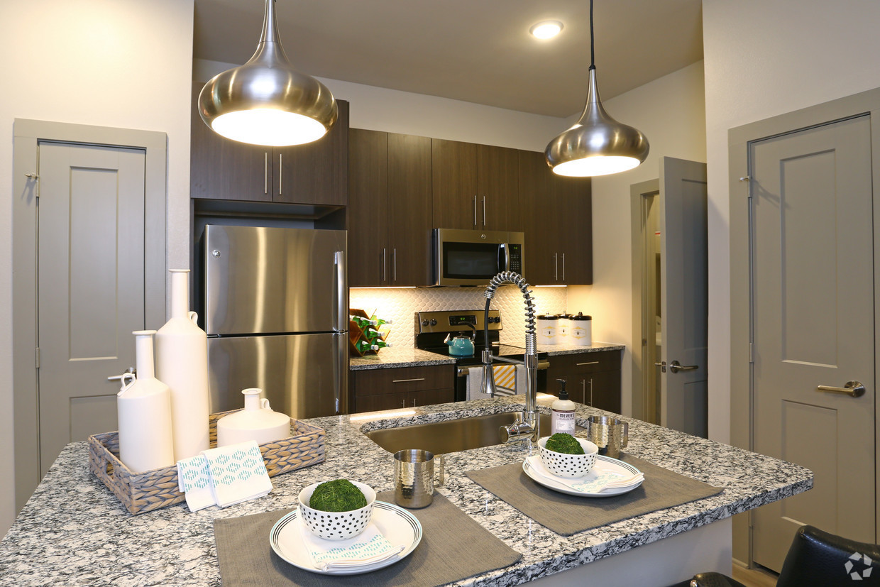 700 East Algonquin Road, Unit 2406 Schaumburg, IL 60173 - Photo 7 of 25 a kitchen with stainless steel appliances granite countertop a dining table and chairs