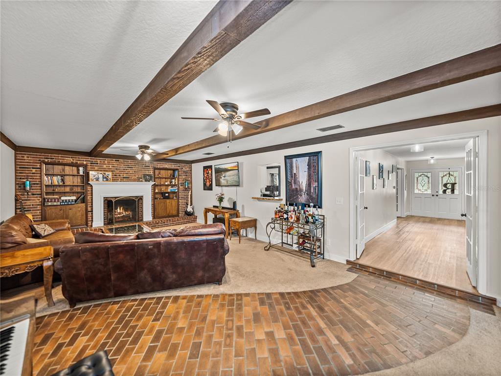 609 West Pipkin Road Lakeland, FL 33813 - Photo 27 of 72 a living room with furniture and a fireplace