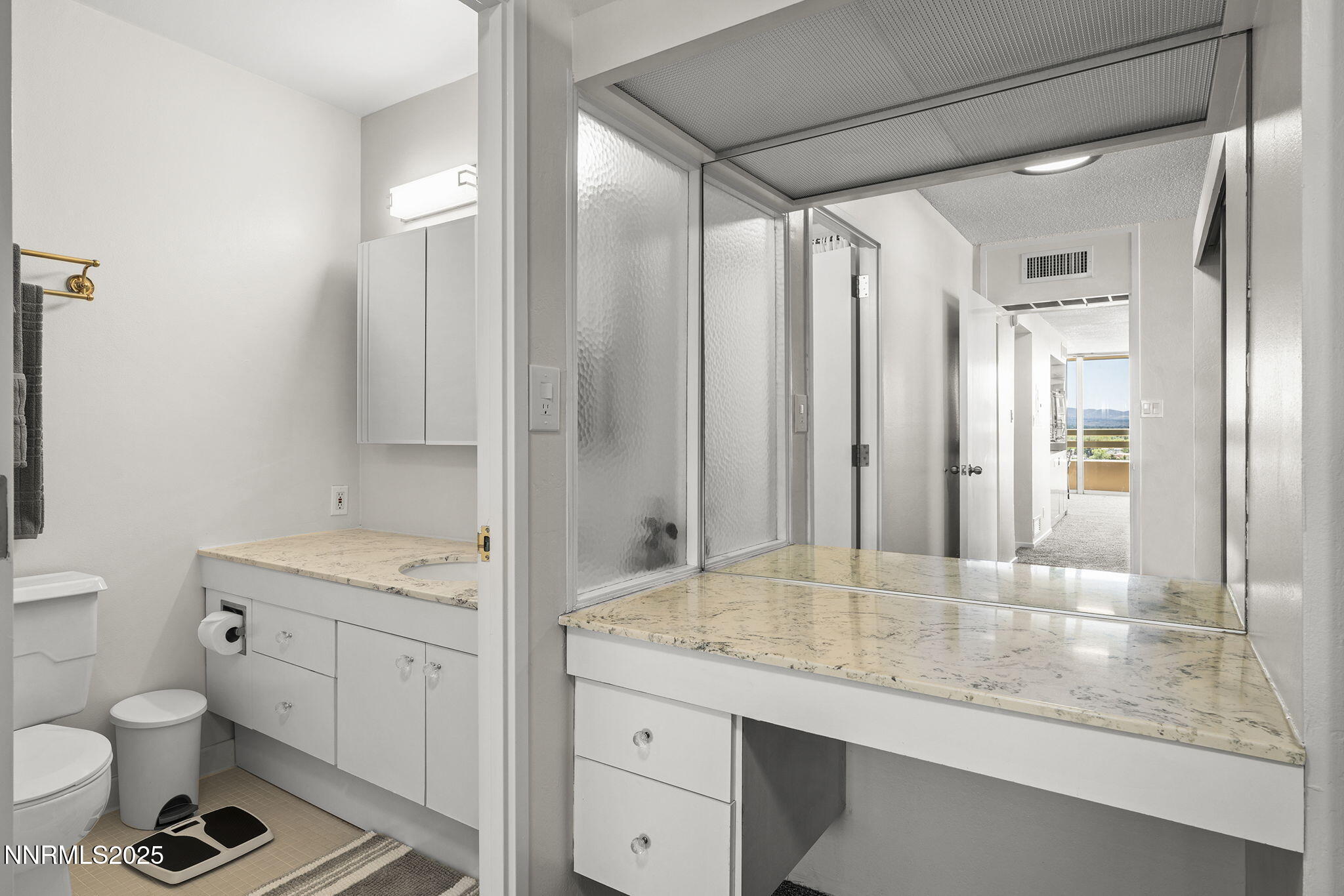 100 North Arlington Avenue, Unit 10E Reno, NV 89501 - Photo 15 of 47 a bathroom with a granite countertop sink toilet and shower