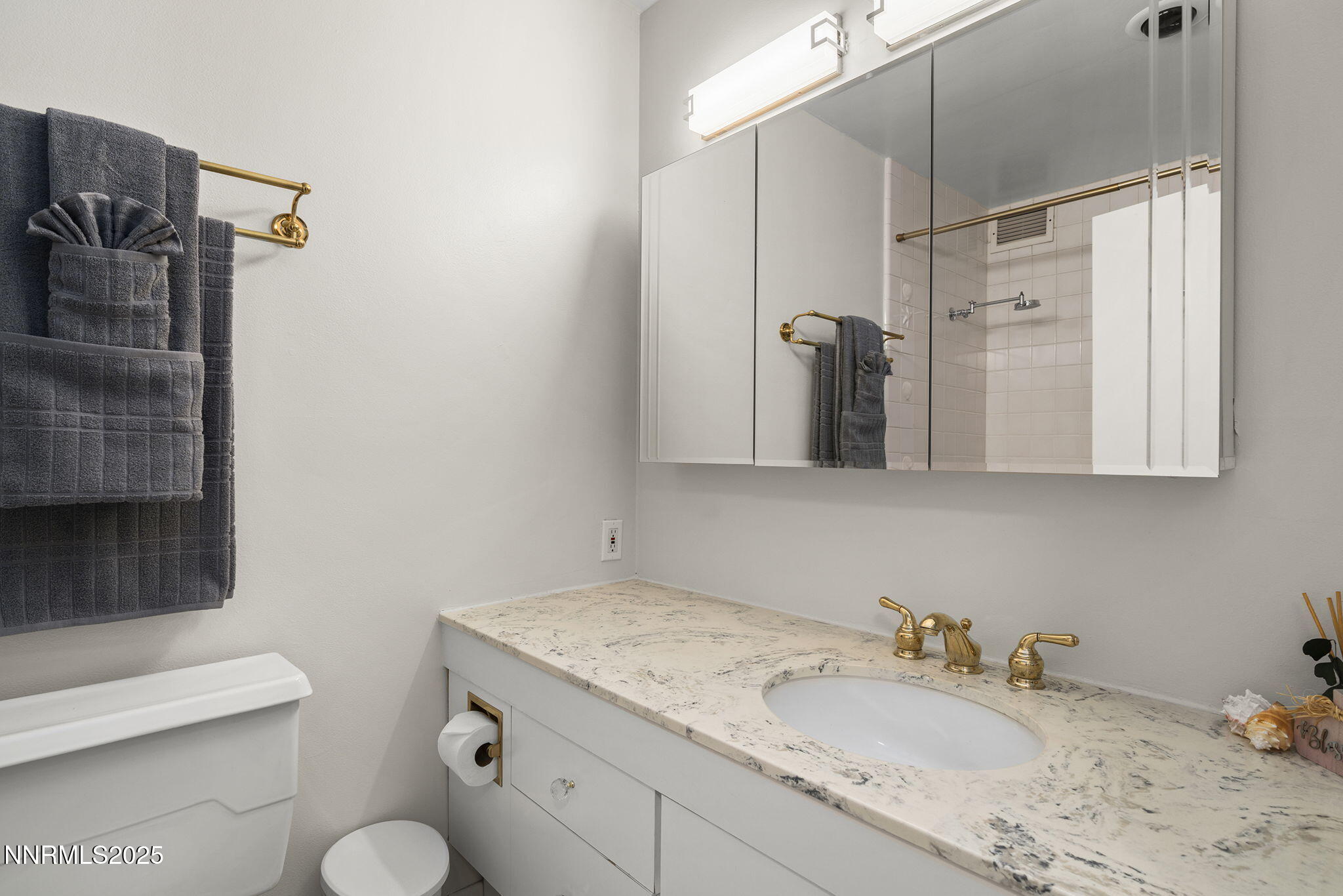 100 North Arlington Avenue, Unit 10E Reno, NV 89501 - Photo 16 of 47 a bathroom with a granite countertop sink toilet and shower