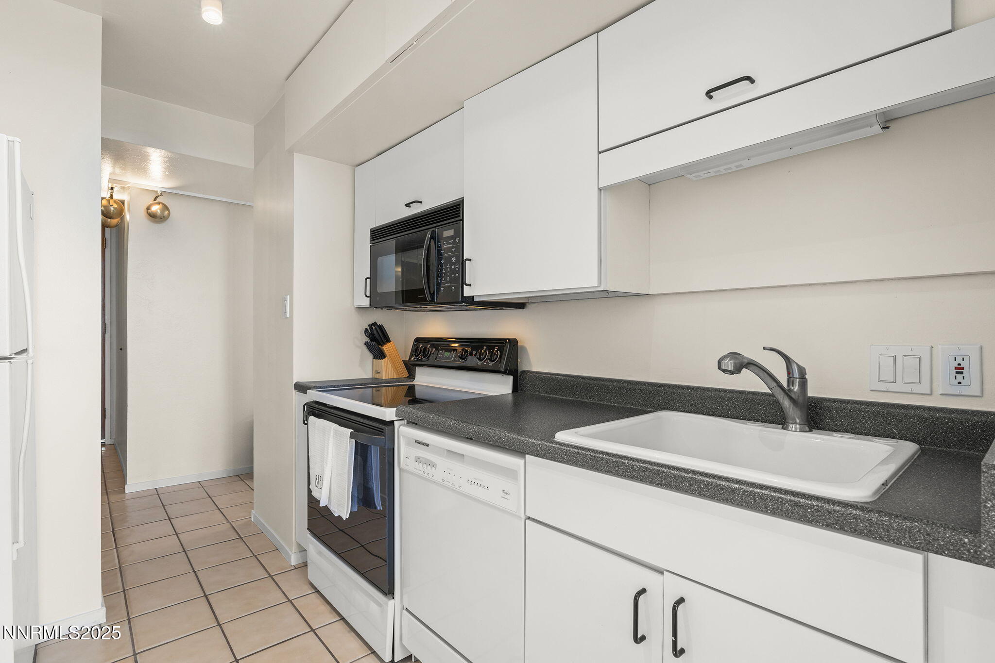 100 North Arlington Avenue, Unit 10E Reno, NV 89501 - Photo 10 of 47 a kitchen with stainless steel appliances granite countertop a sink and a stove