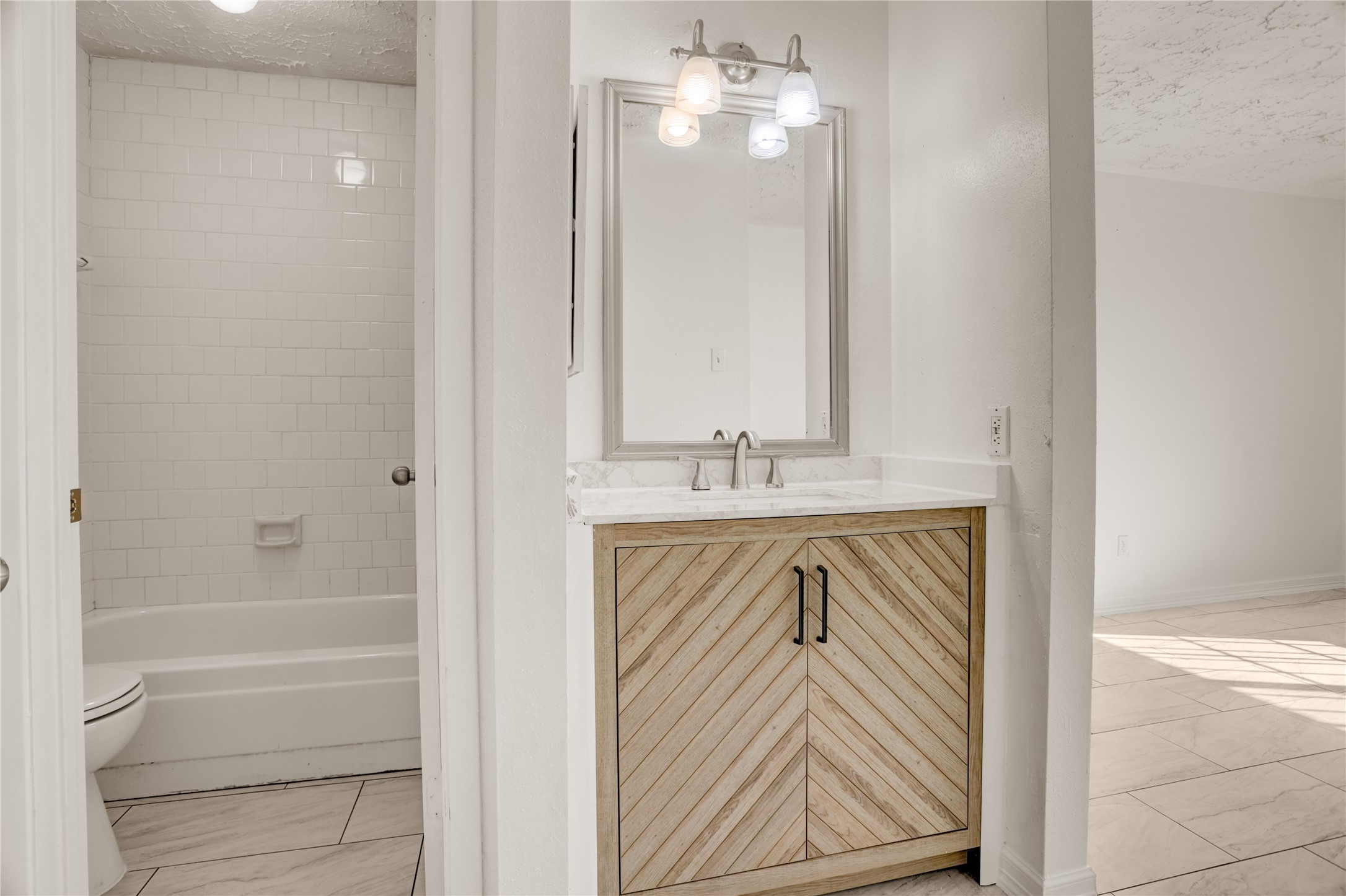 5437 Ridge Wind Lane Houston, TX 77053 - Photo 8 of 11 Updated bathroom with fresh finishes.