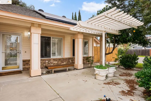 a view of a patio with table and chairs and potted plants