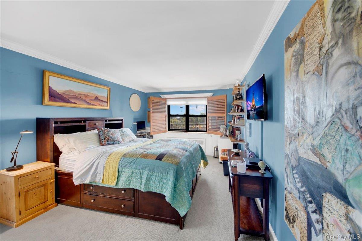 266 Pelham Road, Unit 5H New Rochelle, NY 10805 - Photo 12 of 27 a bedroom with a bed and a flat screen tv