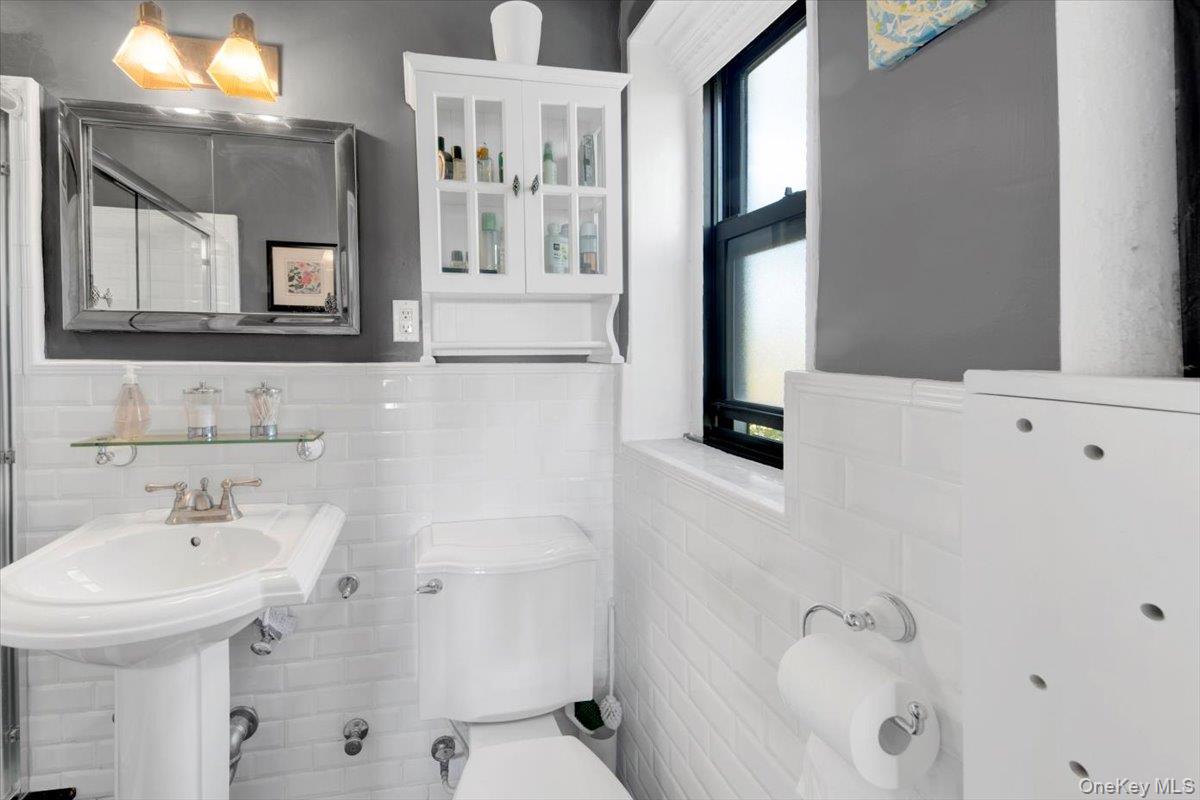 266 Pelham Road, Unit 5H New Rochelle, NY 10805 - Photo 13 of 27 a bathroom with a sink a toilet and mirror