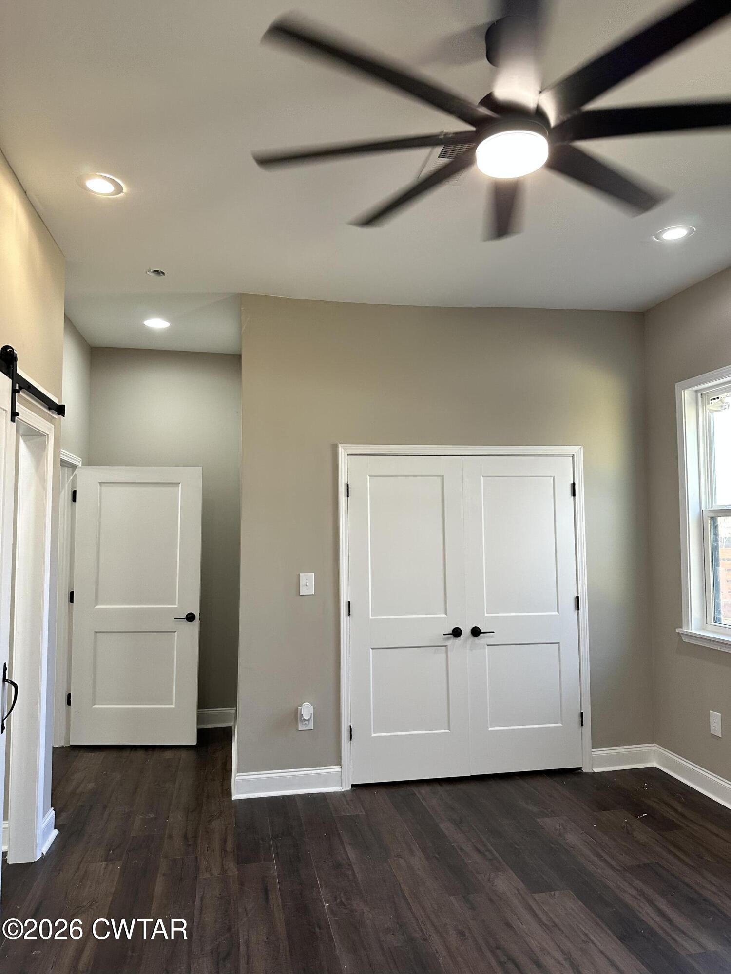 237 Talbot Street Jackson, TN 38301 - Photo 18 of 38 an empty room with wooden floor and windows