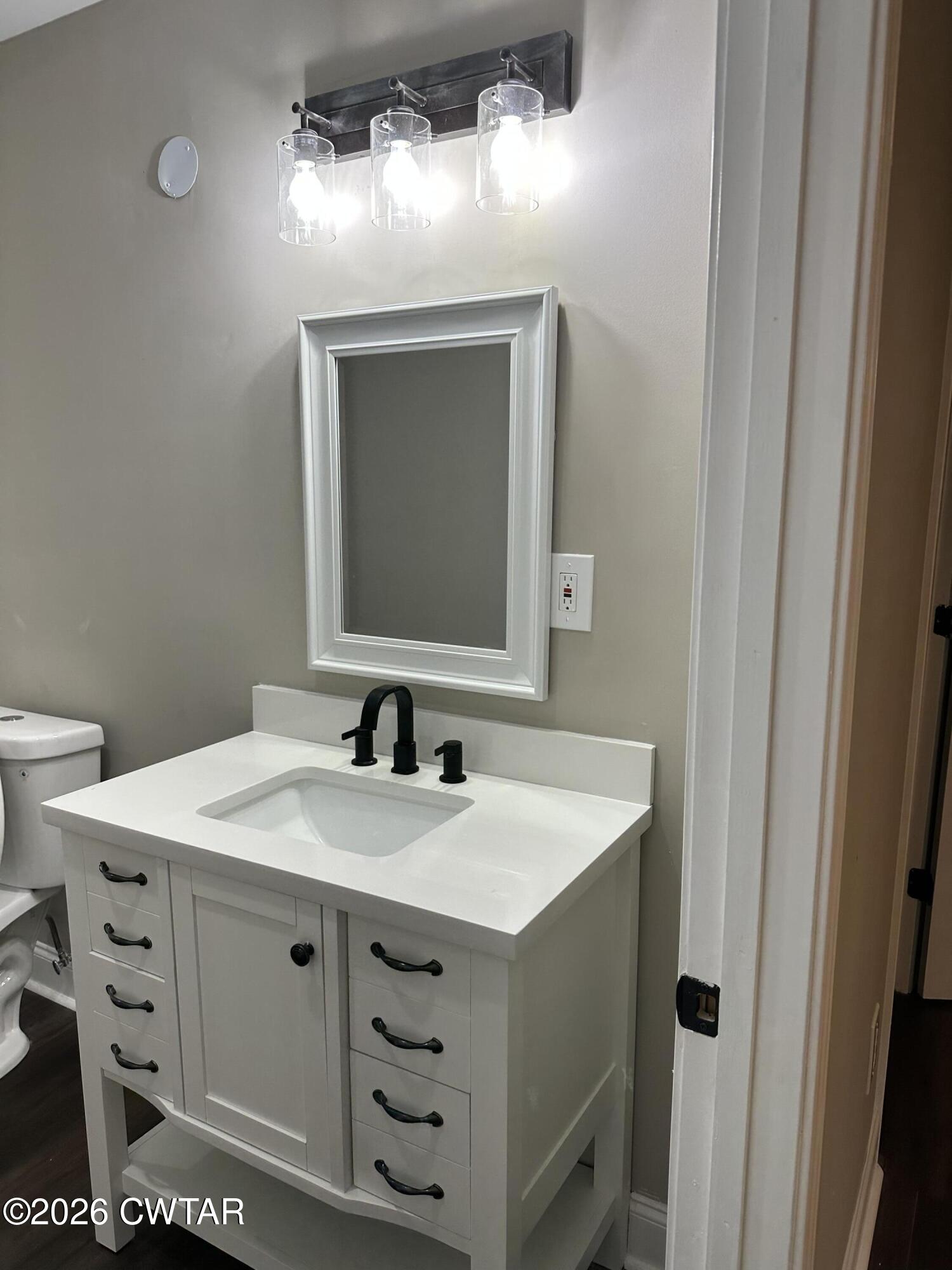 237 Talbot Street Jackson, TN 38301 - Photo 27 of 38 a bathroom with a sink vanity and a mirror