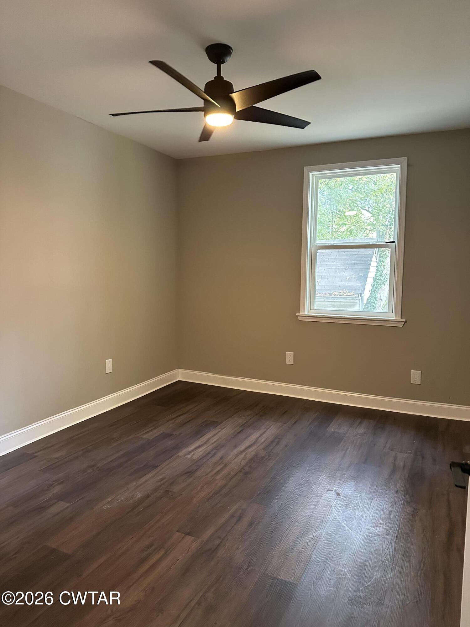 237 Talbot Street Jackson, TN 38301 - Photo 30 of 38 a view of an empty room with wooden floor and a window