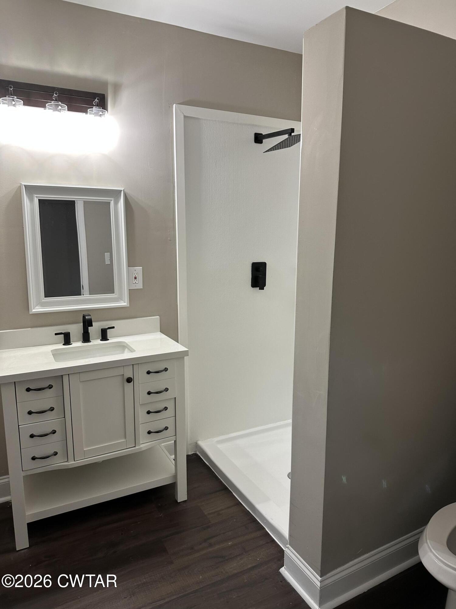 237 Talbot Street Jackson, TN 38301 - Photo 31 of 38 a bathroom with a double vanity sink toilet and mirror