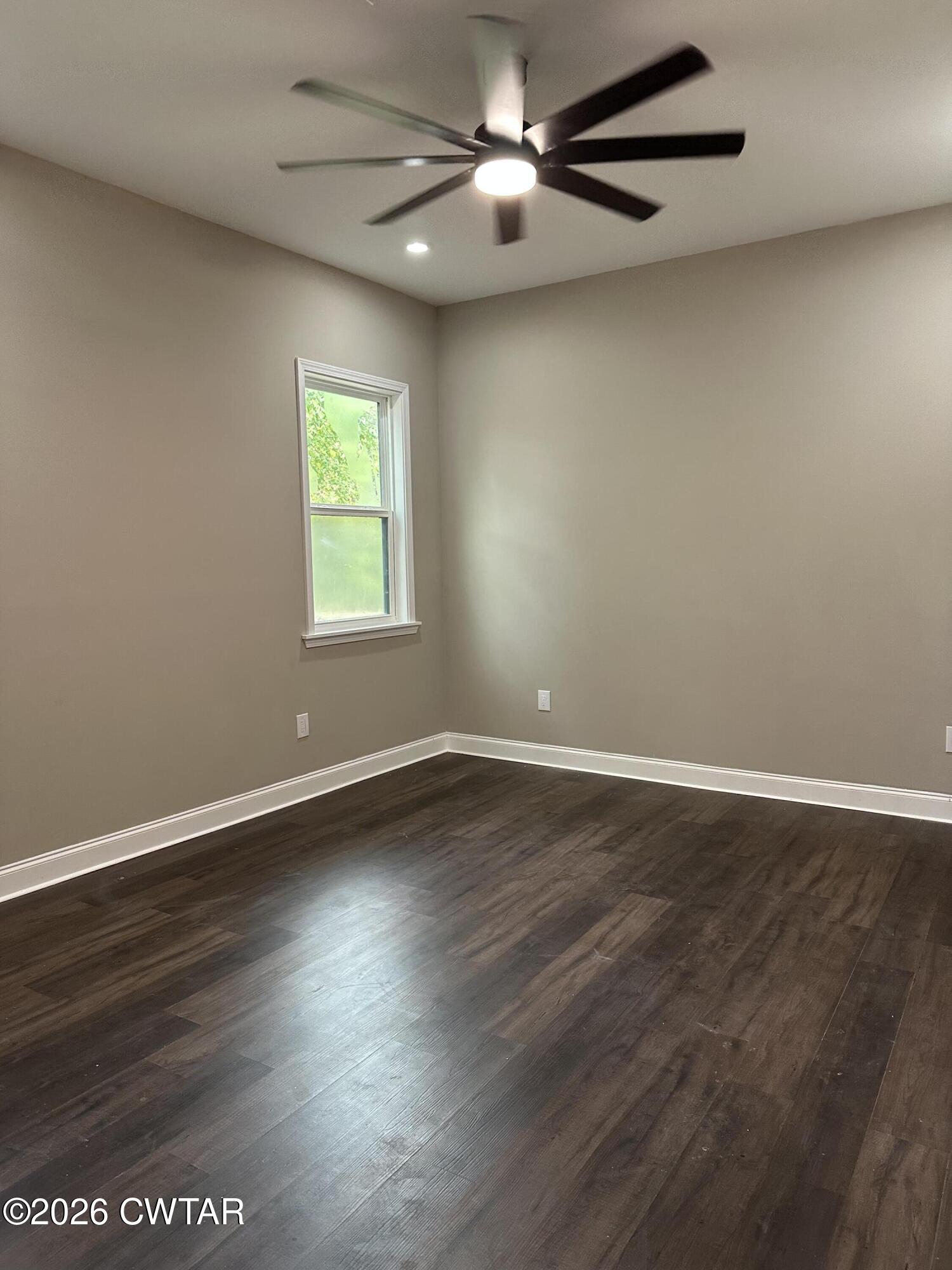 237 Talbot Street Jackson, TN 38301 - Photo 32 of 38 an empty room with wooden floor fan and windows