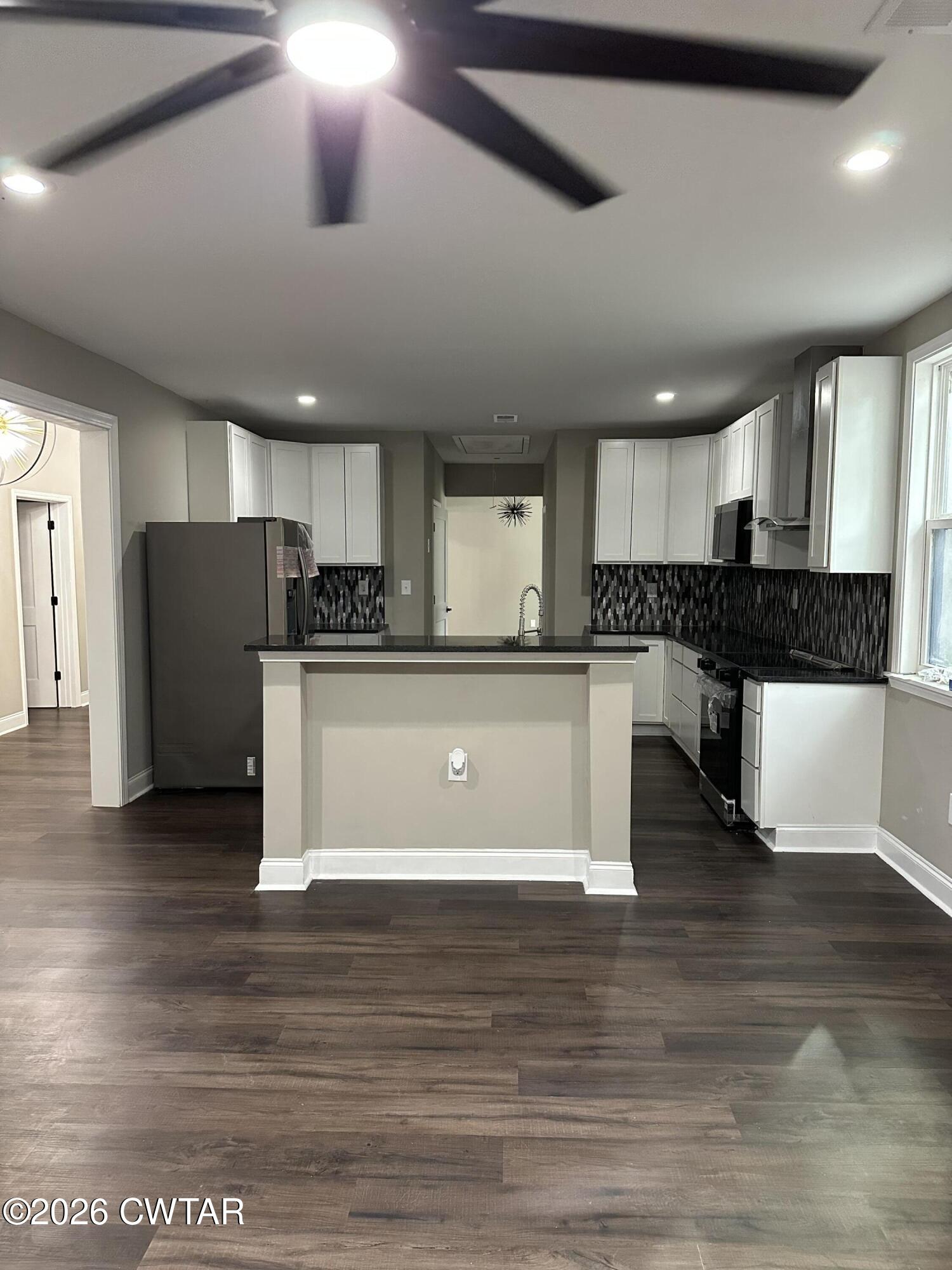 237 Talbot Street Jackson, TN 38301 - Photo 34 of 38 a large kitchen with stainless steel appliances granite countertop a stove a sink dishwasher and a refrigerator